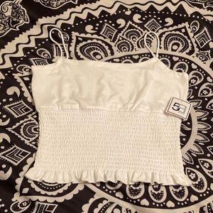 A white ruffled tank. Size small.